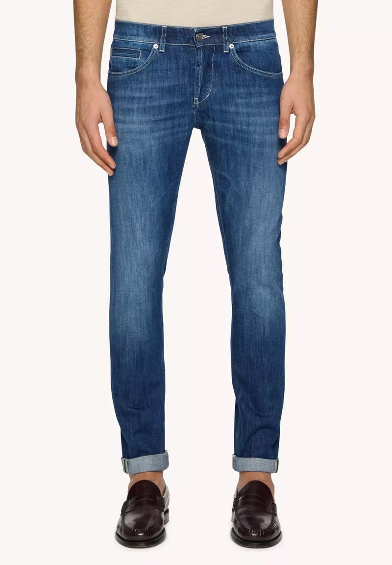 Jeans in denim blu skinny-fit con lavaggio medio, dotati di cinque tasche, orli arrotolati e un dettaglio di cucitura a contrasto.