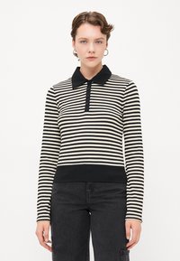 Svart og kremstripet langermet polo-shirt med svart krage, knappelukking og ribbet falde. Glatt stoff med en tettsittende silhuett.