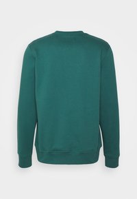 Tmavě petrolejová mikina s kulatým výstřihem, žebrovanými manžetami a lemem. Hladká textura tkaniny, bez viditelných vzorů nebo grafik na zádech.