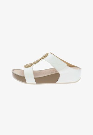 Sandale compensée blanche à bout ouvert avec semelle beige, deux accents ovales décoratifs or et strass sur des larges brides, et semelle intérieure rembourrée.