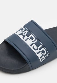 Infradito blu navy con finitura opaca, dotati di una larga fascia con logo bianco. Suola testurizzata per aderenza e durata.