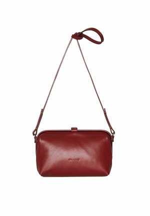 Red leather crossbody bag with a smooth texture, rectangular shape, slim design, featuring a strap and a subtle embossed logo.