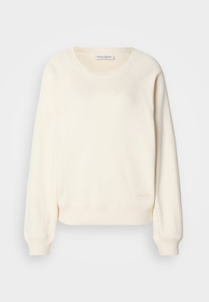 Cream-colored sweatshirt in soft fabric, featuring raglan sleeves, ribbed cuffs and hem, with a subtle logo at the lower edge.