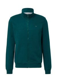 Türkise Zip-Jacke aus weichem Stoff. Sie verfügt über einen Stehkragen, gerippte Bündchen und eine Brusttasche mit einem kleinen Logo. Glatte Textur.