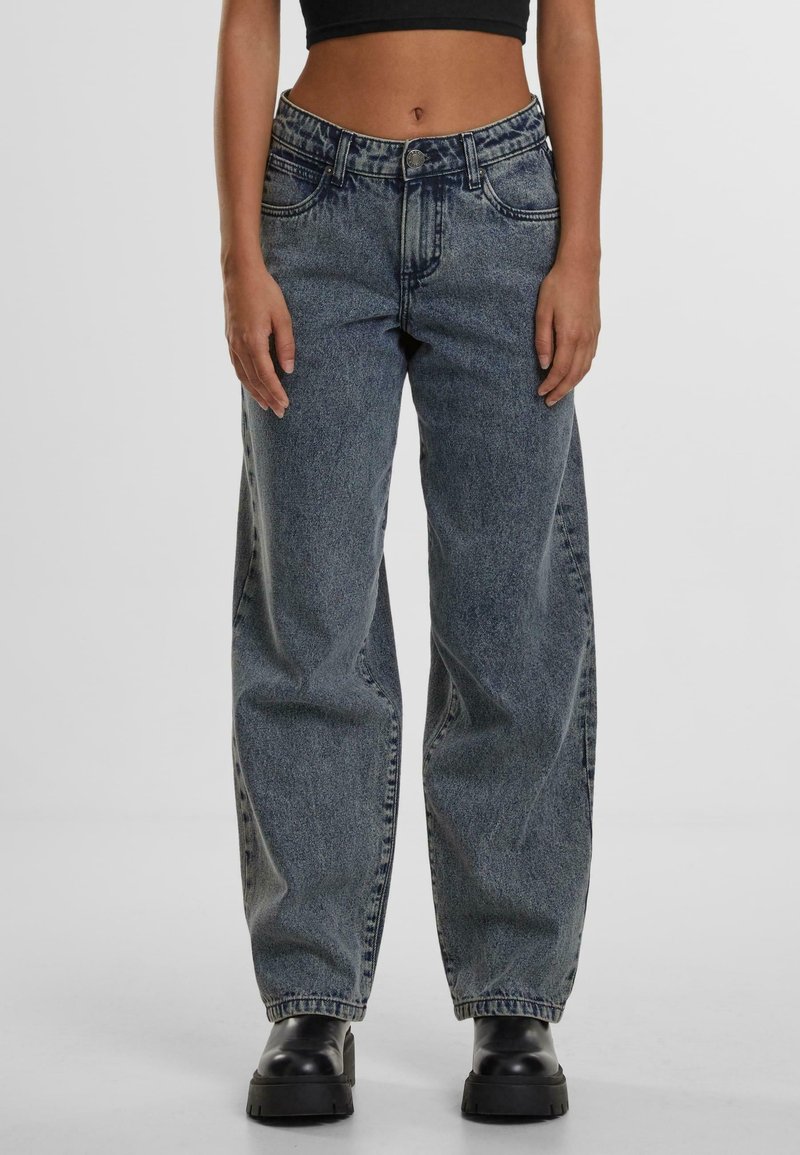 Wide-leg high-waisted jeans in faded blue denim, featuring front pockets, belt loops, and a slightly distressed texture.