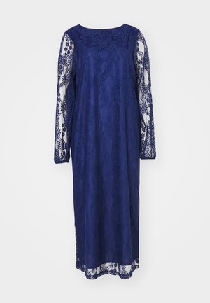 Tumši zila mežģīņu kleita ar garām piedurknēm, apaļas kakla izgriezums un sarežģīti ziedu raksti. Plūsto�ša silueta ar smalku apdari.