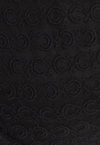 Black textured fabric featuring an embossed circular pattern. The surface is smooth, with a subtle sheen and intricate detailing.