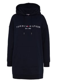 Vestido sudadera azul marino con bolsillo canguro, capucha con cordón y logo blanco "TOMMY HILFIGER EST. 1985" en la parte frontal. Material de algodón suave.