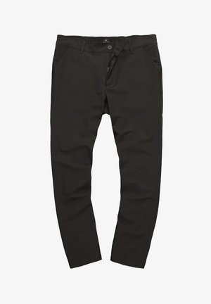 Mustat, joustavat housut, joissa on sileä pinta, nappi- ja vetoketjukiinnitys, kaksi etutaskua ja pieni vihreä yksityiskohta kyljessä.