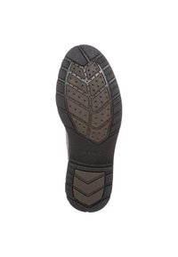 Svart gummisul med texturerat mönster, med små dräneringshål och en lätt klack för grepp och fäste.