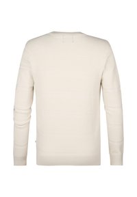 Light cream knitted sweater with long sleeves, ribbed cuffs, texture variations, and subtle horizontal stripes across the fabric.