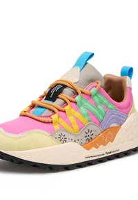 Multicolored sneaker features pink, yellow, green, and gray panels, textured materials, prominent laces, and a rugged black sole with orange accents.