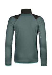 Langärmlige, türkisfarbene Basisschicht aus strukturiertem Stoff, mit schwarzen Schulterakzenten und einem Stehkragen. Mit einem Logo auf dem rechten Ärmeln.