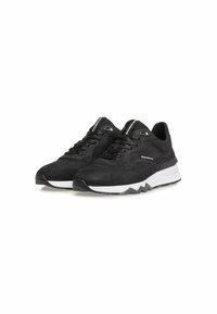 Sneaker in suede nero con superficie texture, suola bianca e grigia, design con lacci e dettagli in mesh sulla linguetta.