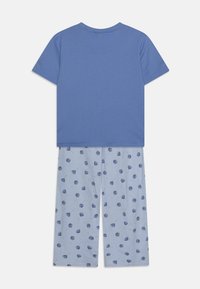 Blue short-sleeve T-shirt paired with light blue pants featuring repeated dark blue lollipop patterns. Soft cotton material, casual fit.