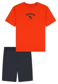 Red cotton t-shirt with a South Beach graphic and navy shorts. T-shirt has a crew neck and short sleeves; shorts feature an elastic waistband.