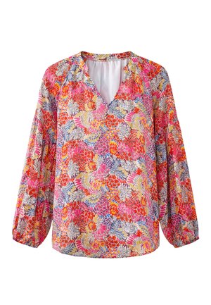 Blouse à manches longues avec col en V, présentant un motif floral coloré dans des tons rose, rouge, orange, jaune et bleu sur un fond clair.
