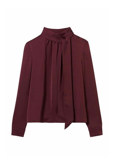 Blusa bordeaux a maniche lunghe con collo annodato, davanti plissettato e dettagli con bottoni sulla spalla. Tessuto morbido con una texture liscia.