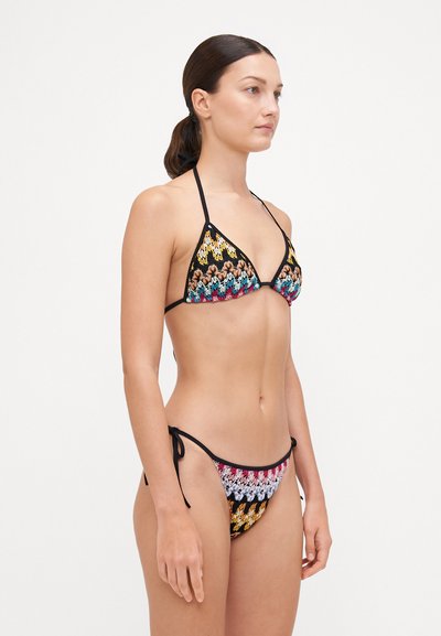 Bikini-Set mit einem gehäkelten Design in Schwarz und mehrfarbigen Zickzackmustern, Triangel-Oberteil und verstellbaren Bindebändern an den Seiten.