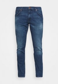 Blå denimjeans med en smal passform, femfickorsdesign, kontrasterande sömmar och knappstängning i midjan. Lätt blekt finish.
