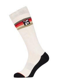 Knielange sok in crème met zwarte teen en hiel. Bevat horizontale strepen in rood en groen. Logo-patch nabij de bovenkant. Gladde textuur.