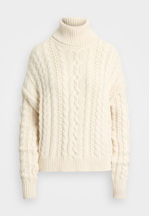 Cable-knit turtleneck sweater in cream, featuring ribbed cuffs and hem, a textured pattern, and a relaxed, oversized fit.