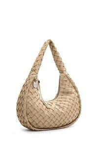 Beige woven handbag with a unique curved shape, featuring a single strap and a zipper closure. Includes a small metal accent tag.