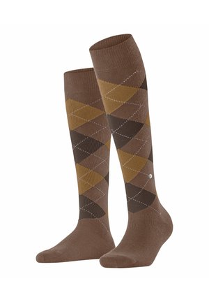 Braune kniehohe Socken mit einem Rautenmuster in Dunkelbraun, Hellbraun und Senfgelb, mit weißen Akzenten und einem Logo an der Seite.