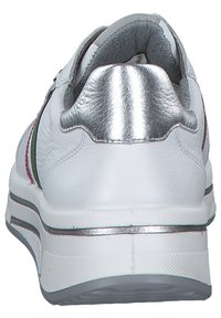White sneaker with smooth leather upper, silver accent at the heel, and colorful stripe detailing. Textured sole provides grip and support.