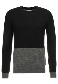 Langarm-Pullover mit einem schwarzen Oberteil und einem grauen Unterteil, aus einem glatten Strickmaterial gefertigt und mit einem Rundhalsausschnitt.