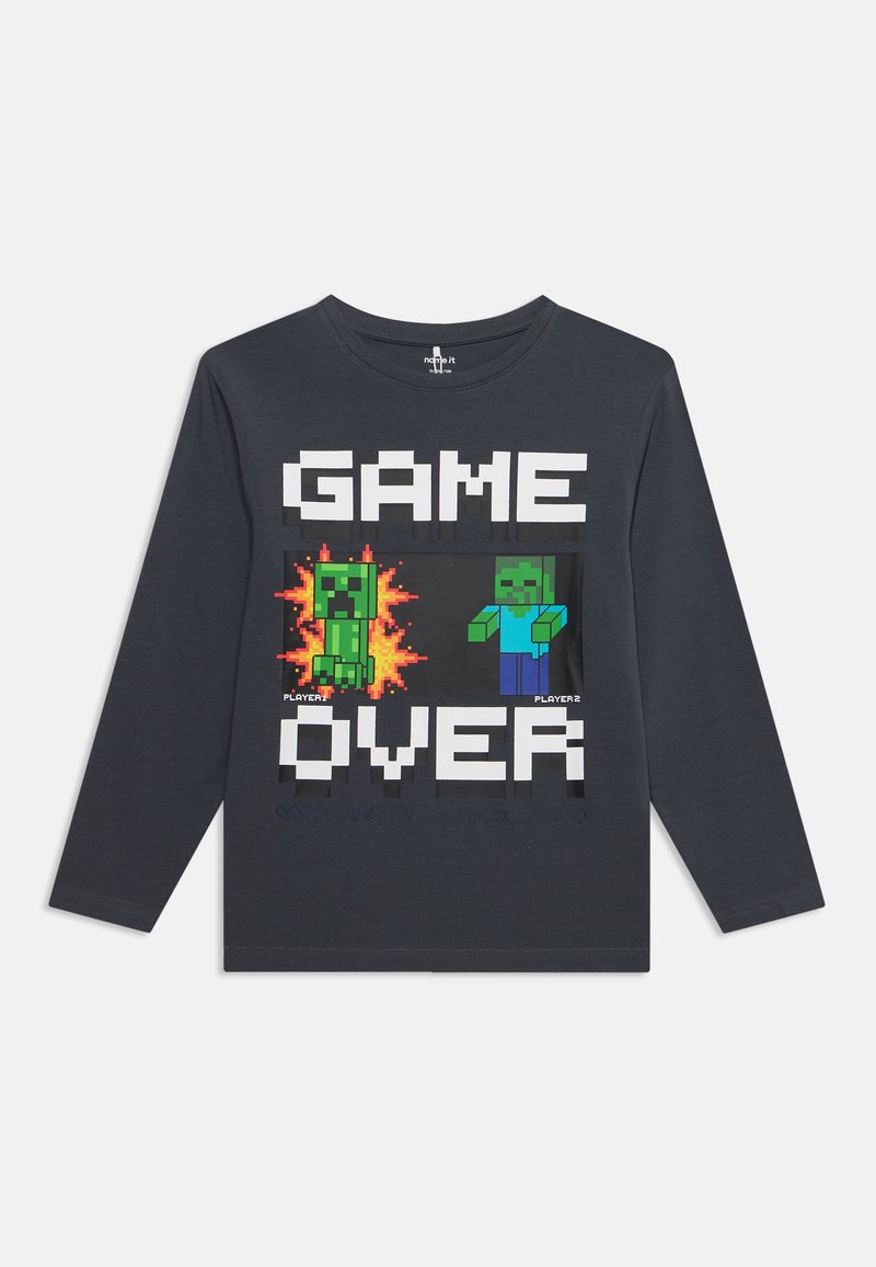 Chemise gris foncé à manches longues avec des personnages de jeu pixelisés et le texte "GAME OVER" en lettres majuscules à l'avant.