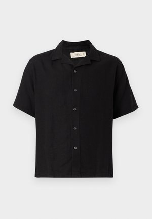 Must värviline lühikeste varrukatega särk, mis on valmistatud linase segu kangast, laia krae, ees oleva nupuga sulgemise ja mugava lõikega. Pehme tekstuur, minimaalne disain.