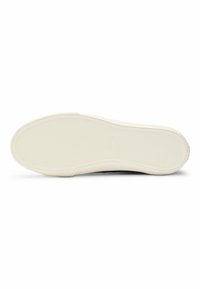 Black sneaker with a textured rubber sole, featuring a cream-colored outsole and no visible branding. Sleek, modern design with clean lines.