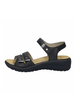 Black leather sandals feature two adjustable straps with silver hardware, a cushioned footbed, and a low wedge sole for comfort.