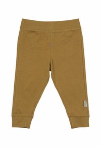 Hellbraune Baumwollleggings mit einem gerippten Bund, schmal zulaufenden Knöcheln und einem kleinen seitlichen Etikett. Glatte Textur mit einem leichten Glanz.