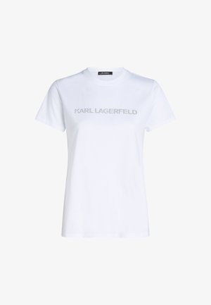 Biała bawełniana koszulka z krótkim rękawem i okrągłym dekoltem, z nadrukiem srebrnym tekstem "KARL LAGERFELD" na piersi, pisaną odważną czcionką.