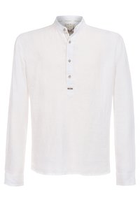 Weißes Leinenhemd mit langen Ärmeln und Stehkragen, dreiknöpfiger Knopfleiste und kleinem Logo-Akzent am Saum. Glatte Textur, leicht.