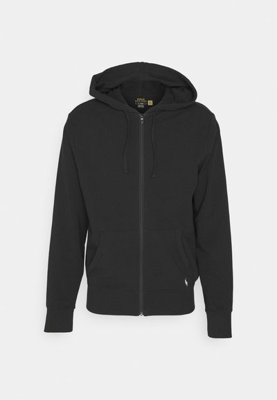 Hoodie nero con zip realizzato in tessuto misto cotone. Presenta una cerniera frontale, un cappuccio con stringhe e tasche frontali con polsini elasticizzati.