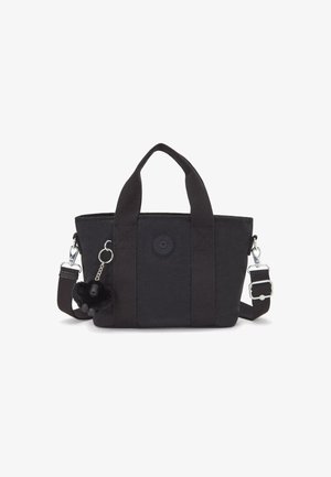 Black canvas handbag with short handles and a detachable shoulder strap. Features a round logo and a decorative furry charm.