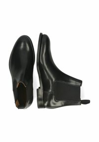 Botas Chelsea de cuero negro con paneles elásticos en los laterales, punta redonda y suela texturizada. Acabado liso con lengüeta en la parte posterior.