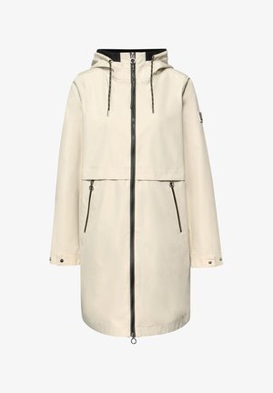 Beige regenjas tot op de knie met capuchon, zwarte volledige ritssluiting, twee voorvakken met rits, verstelbare mouwboorden en trekkoorden aan de capuchon.