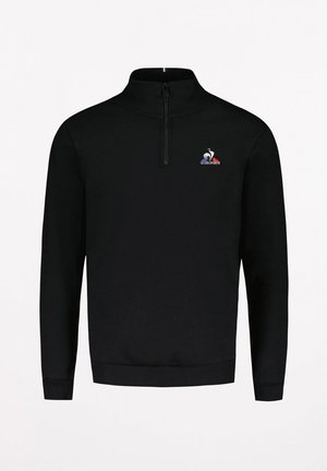 Sweatshirt noir à fermeture éclair quart avec un col haut, des poignets côtelés et un petit logo brodé avec des accents bleu, blanc et rouge. Texture douce.