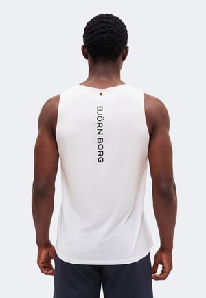 Αθλητικός άνδρας που φαίνεται από πίσω με άσπρο αμάνικο μπλουζάκι που έχει κάθετα στο κέντρο της πλάτης το κείμενο «BJÖRN BORG».