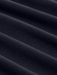 Tessuto blu navy scuro con una fine trama diagonale visibile e pieghe morbide che creano ombre delicate e texture.