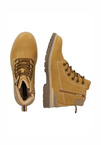 Bruna kängor i midjehöjd tillverkade av smidig läder. Har snörningsdesign, vadderad krage, sidodragkedja och strukturerad gummisula för bra grepp.