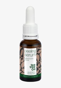 Bursztynowa szklana butelka z białą zakraplaczem. Etykieta z zielonym tekstem na białym tle, z brązowym abstrakcyjnym wzorem i szczegółami marki.