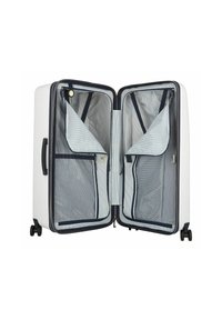 Valigia rigida bianca, gli interni presentano tasche in rete e foderatura navy. Due scomparti e ruote scorrevoli per un facile trasporto.