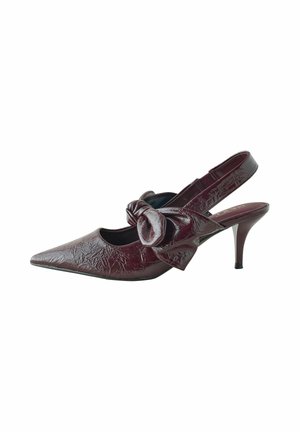 Burgundy patent leather slingback pump with a pointed toe and a bow accent on the side. Features a thin heel and textured finish.