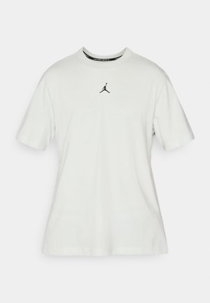 T-shirt en coton gris clair avec col rond, manches courtes et logo Jordan noir central. Texture lisse, coupe classique.