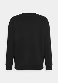Sweat-shirt noir à manches longues et col rond, montré de dos sur un fond clair uni.